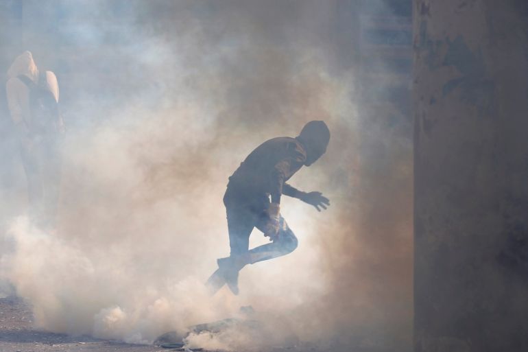 A demonstrator runs away from tear gas during ongoing anti-government protests in Baghdad, Iraq November 24, 2019. REUTERS/Khalid al-Mousily