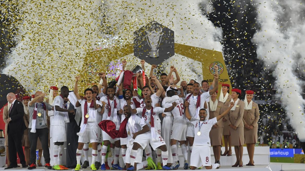 ABU DHABI, UNITED ARAB EMIRATES - FEBRUARY 01: Players of Qatar celebrates their victory as Hasan Al Haydos lifts the trophy after the AFC Asian Cup final match between Japan and Qatar at Zayed Sports City Stadium on February 01, 2019 in Abu Dhabi, United Arab Emirates. (Photo by Koki Nagahama/Getty Images)