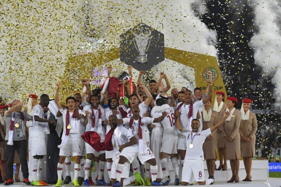 ABU DHABI, UNITED ARAB EMIRATES - FEBRUARY 01: Players of Qatar celebrates their victory as Hasan Al Haydos lifts the trophy after the AFC Asian Cup final match between Japan and Qatar at Zayed Sports City Stadium on February 01, 2019 in Abu Dhabi, United Arab Emirates. (Photo by Koki Nagahama/Getty Images)