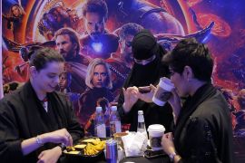 epa06703171 A Saudi woman wears a niqab (C) as others eat and drink during the inaugration of the first VOX Cinema at Riyadh park mall, in Riyadh, Saudi Arabia, 30 April 2018. The multiplex theater will feature four screens. Marvel's Black Panther...