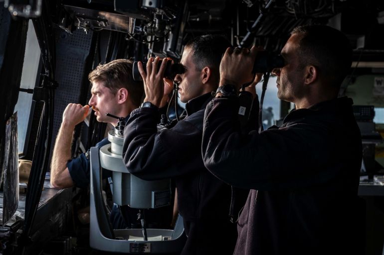 Officer of the Deck Lt. j.g. Tucker Bonow, Conning Officer Ensign Juan Curbelo and Lt. Cmdr. Rory Schneider, the executive officer of the U.S. Navy amphibious transport dock ship USS Green Bay, scan the horizon from the bridge while standing watch in the Taiwan Strait August 23, 2019. Picture taken August 23, 2019. U.S. Navy/Mass Communication Specialist 2nd Class Markus Castaneda/Handout via REUTERS. THIS IMAGE HAS BEEN SUPPLIED BY A THIRD PARTY.