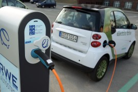 BERLIN - APRIL 01: A company electric Smart car of German engineering company Siemens, at the behest of the photographer, stands attached via a charging cable from a sidewalk-mounted charger on April 1, 2010 in Berlin, Germany. German power producer RWE has erected and is operating over 50 charging columns across Berlin in a pilot project to promote the use of electric cars, and the company is expanding the program across Germany. Siemens is not involved in the project but is running several electric cars from the RWE chargers in Berlin. (Photo by Illustration Sean Gallup/Getty Images)