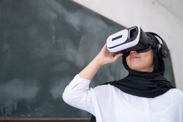 Smiling Young Woman Using Virtual Reality In Classroom