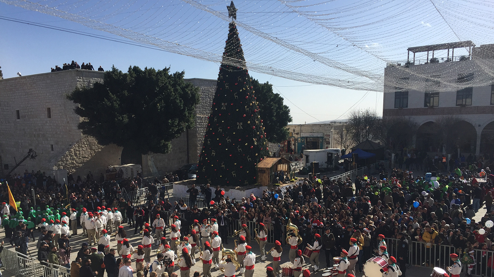 ‪فرق كشفية تمر وسط الفلسطينيين والسياح في كنيسة المهد ببيت لحم في عيد الميلاد للطوائف المسيحية‬ (الجزيرة)