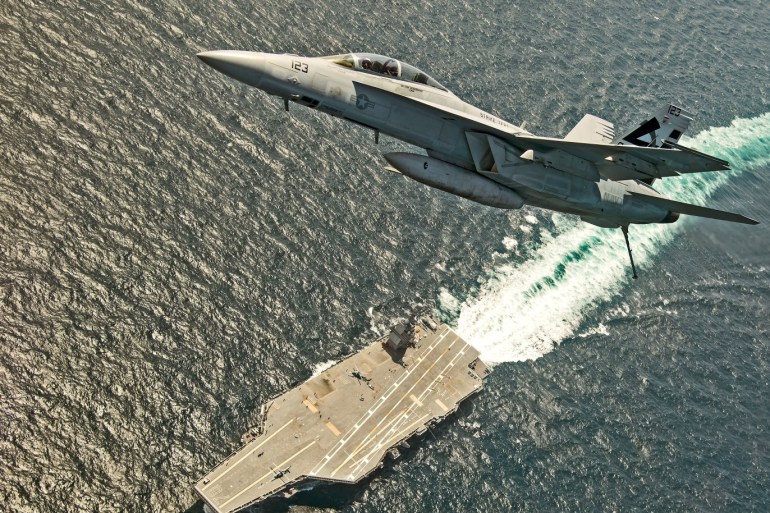 An F/A-18F Super Hornet jet flies over the USS Gerald R. Ford as the U.S. Navy aircraft carrier tests its EMALS magnetic launching system, which replaces the steam catapult, and new AAG arrested landing system in the Atlantic Ocean July 28, 2017. Picture taken July 28, 2017. U.S. Navy/Erik Hildebrandt/Handout via REUTERS ATTENTION EDITORS - THIS IMAGE WAS PROVIDED BY A THIRD PARTY?