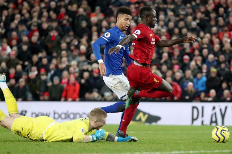 Soccer Football - Premier League - Liverpool v Everton - Anfield, Liverpool, Britain - December 4, 2019 Liverpool's Sadio Mane in action with Everton's Jordan Pickford and Mason Holgate REUTERS/Scott Heppell EDITORIAL USE ONLY. No use with unauthorized audio, video, data, fixture lists, club/league logos or