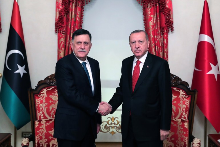 President of Turkey Erdogan meets Fayez Al-Sarraj- - ISTANBUL, TURKEY - NOVEMBER 27: President of Turkey, Recep Tayyip Erdogan (R) shakes hands with Leader of Libya’s UN-recognized government, Fayez Al-Sarraj (L) as they pose for a photo at Dolmabahce Office in Istanbul, Turkey on November 27, 2019.
