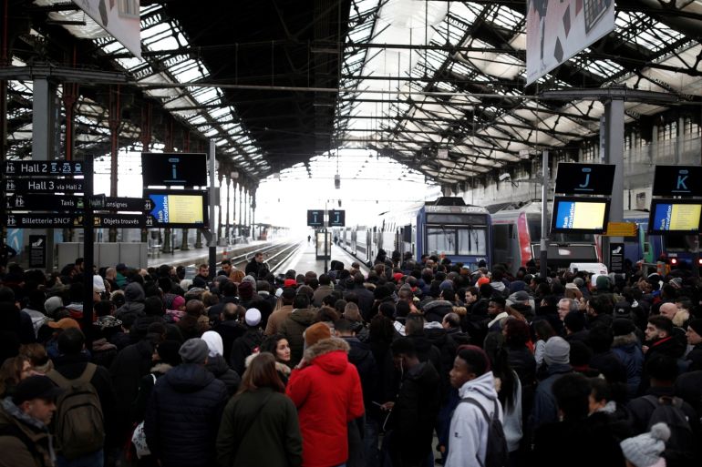 Commuters of French national railway operator SNCF wait on a platform at Gare de Lyon train station as a strike by French SNCF railway and Paris transport network (RATP) workers continues against French government's pensions reform plans, in Paris, France, December 8, 2019. REUTERS/Benoit Tessier