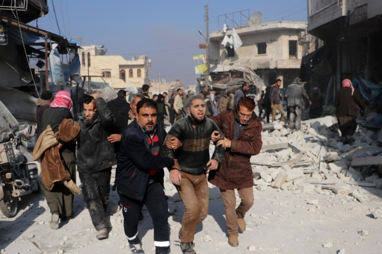 Airstrikes in Syria's Idlib - - IDLIB, SYRIA - DECEMBER 21: Injured Syrians are being moved away from the site after airstrikes carried out by Assad Regime over Saraqib district in the de-escalation zone of Idlib, Syria on December 21, 2019. Airstrikes killed 8 civilians and injured 20 others.