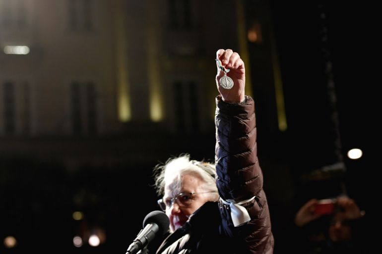 Swedish physician Christina Doctare holds the medal she received while working for the U.N. Peacekeeping force in Bosnia in the 1980s, wanting to return it, as a protest against the awarding of the 2019 Nobel literature prize to Peter Handke during a demonstration in Stockholm, Sweden December 10, 2019. TT News Agency/Stina Stjernkvist via REUTERS THIS IMAGE HAS BEEN SUPPLIED BY A THIRD PARTY. SWEDEN OUT. NO COMMERCIAL OR EDITORIAL SALES IN SWEDEN