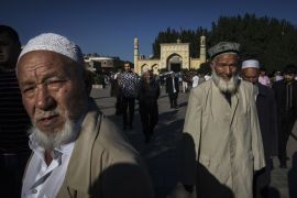 KASHGAR, CHINA - JUNE 26: Ethnic Uyghur men leave prayers marking Eid Al Fitr outside Id Kah Mosque on June 26, 2017 in the old town of Kashgar, in the far western Xinjiang province, China. Kashgar has long been considered the cultural heart of Xinjiang for the province's nearly 10 million Muslim Uyghurs. At an historic crossroads linking China to Asia, the Middle East, and Europe, the city has changed under Chinese rule with government development, unofficial Han Ch