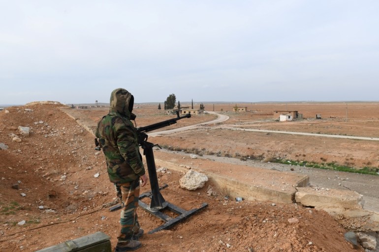 A Syrian Army soldier loyal to Syria's President Bashar al-Assad forces stands next to a military weapon in Idlib, Syria January 21, 2018. Picture taken January 21, 2018. SANA/Handout via REUTERS ATTENTION EDITORS - THIS PICTURE WAS PROVIDED BY A THIRD PARTY. REUTERS IS UNABLE TO INDEPENDENTLY VERIFY THE AUTHENTICITY, CONTENT, LOCATION OR DATE OF THIS IMAGE.