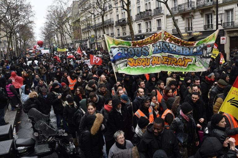 Ongoing protests in Paris- - PARIS, FRANCE - DECEMBER 12: People march during a protest within general strike over French government's plan to overhaul the country's retirement system in Paris, France on December 12, 2019.