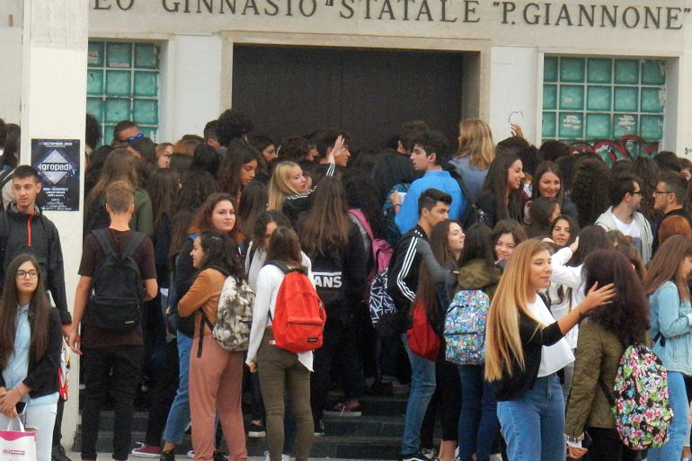 Benevento, Campania, Italy - September 15, 2016: Early in the morning the first day of school at the Liceo State Pietro Giannone. Students are waiting for the opening of doors to take the best places in their classrooms