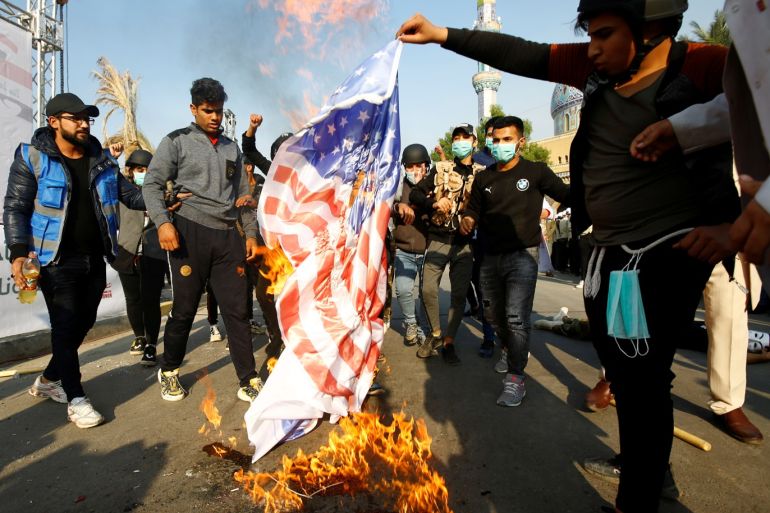 Supporters of Qais al-Khazali, leader of the Asaib Ahl al-Haq Iran-backed militia group, burnt an U.S. flag during a demonstration against U.S sanctions targeting al-Khazali, in Baghdad, Iraq, December 14, 2019. REUTERS/Alaa al-Marjani