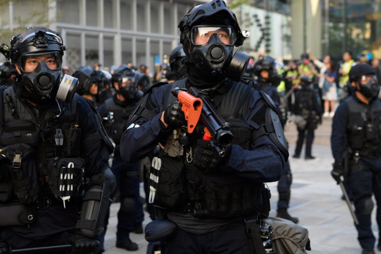 A police officer holds a weapon during the