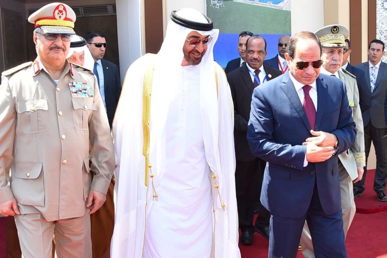 Egyptian President Abdel Fattah al-Sisi (R) arrives with Arab leaders Sheikh Mohammed bin Zayed (C), Crown Prince of Abu Dhabi, and General Khalifa Haftar (L), commander in the Libyan National Army and members of the Egyptian military at the opening of the Mohamed Najib military base, the graduation of new graduates from military colleges, and the celebration of the 65th anniversary of the July 23 revolution at El Hammam City in the North Coast, in Marsa Matrouh, Egypt,