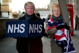 Healthcare professionals dressed as Britain's Prime Minister Boris Johnson and U.S. President Donald Trump attend a demonstration demanding NHS public service must remain protected from commercial exploitation in London, Britain December 9, 2019. REUTERS/Gonzalo Fuentes