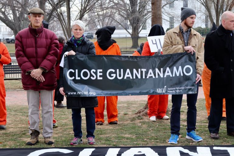 Activists demand Guantanamo Bay's closure near White House- - WASHINGTON DC, USA - JANUARY 12: Protesters, wearing orange prisoner jumpsuits, those symbolize Guantanamo Bay detainees, attend a protest as they hold banner in front of the White House in Washington D.C, United States on January 12, 2018. The protesters demanded the closure of the detention center at the U.S. Naval Base in Guantanamo Bay, Cuba on its 16th anniversary.