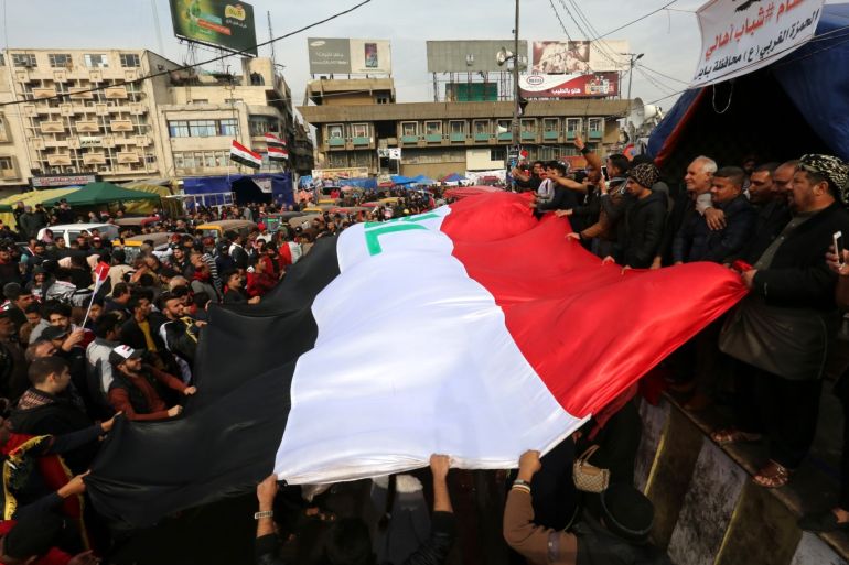 epa08059380 Iraqi protesters carry the Iraqi national flag and chant during a protest at the Al Tahrir square in central Baghdad, Iraq, 10 December 2019. Protests continue in Baghdad and southern Iraqi cities since October 2019 with rising casualties of more than 260 people, while protesters are calling for the resignation of all senior officials in the country after Prime Minister Adel Abdul Mahdi stepped down. EPA-EFE/AHMED JALIL