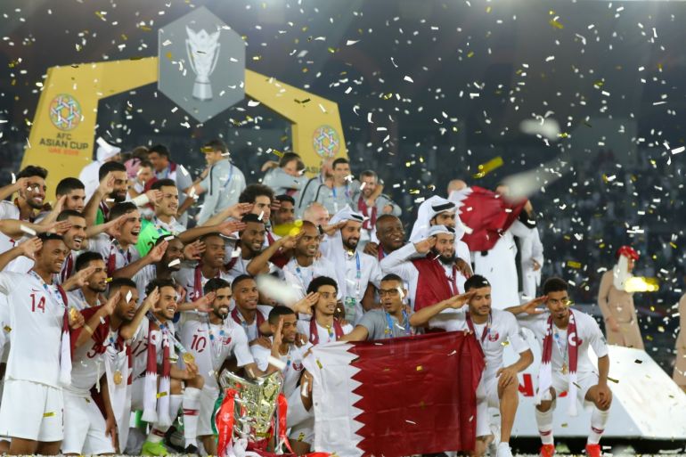 ABU DHABI, UNITED ARAB EMIRATES - FEBRUARY 01: Players of Qatar celebrates with the AFC Asian Cup trophy following their victory in the AFC Asian Cup final match between Japan and Qatar at Zayed Sports City Stadium on February 01, 2019 in Abu Dhabi, United Arab Emirates. (Photo by Francois Nel/Getty Images)