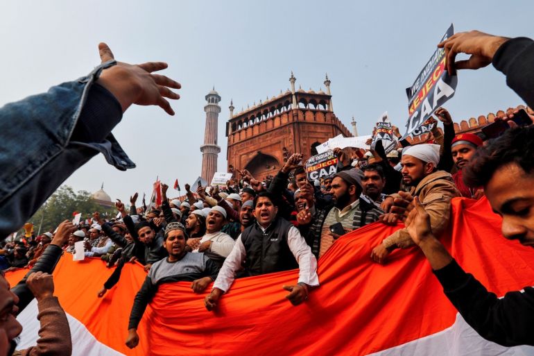 FILE PHOTO: Demonstrators hold the national flag of India as they attend a protest against a new citizenship law, after Friday prayers at Jama Masjid in the old quarters of Delhi, India, December 20, 2019. REUTERS/Danish Siddiqui/File Photo