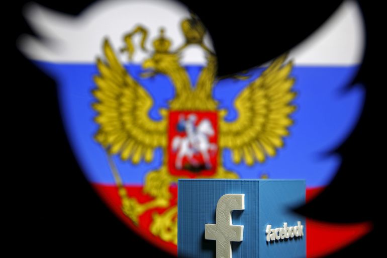 A Russian flag and a 3D model of the Facebook logo is seen through a cutout of the Twitter logo in this photo illustration taken in Zenica, Bosnia and Herzegovina, May 22, 2015. Russia's media watchdog has written to Google, Twitter and Facebook warning them against violating Russian Internet laws and a spokesman said on Thursday they risk being blocked if they do not comply with the rules. Roskomnadzor said it had sent letters this week to the three U.S.-based Internet firms asking them to comply with Internet laws which critics of President Vladimir Putin have decried as censorship. REUTERS/Dado Ruvic TPX IMAGES OF THE DAY