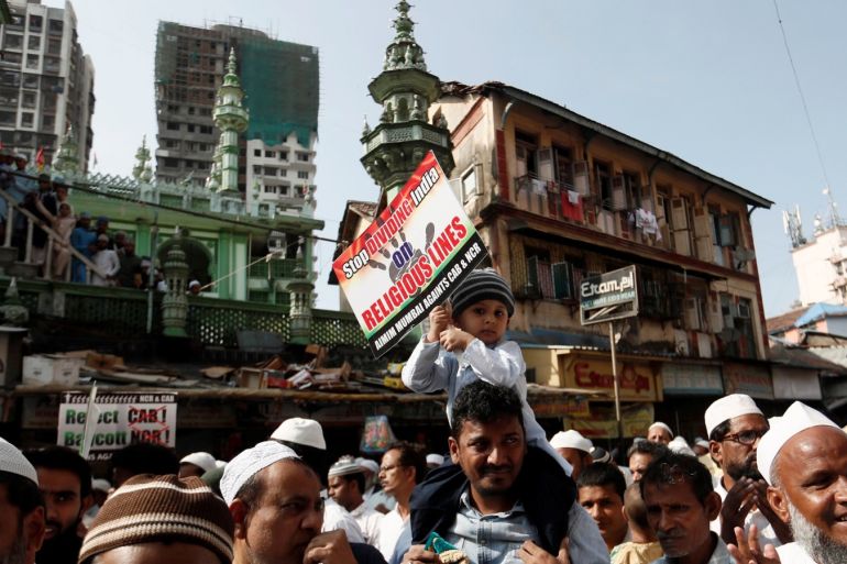 A boy holds a placard during a protest against the Citizenship Amendment Bill, a bill that seeks to give citizenship to religious minorities persecuted in neighbouring Muslim countries, in Mumbai, India December 13, 2019. REUTERS/Francis Mascarenhas