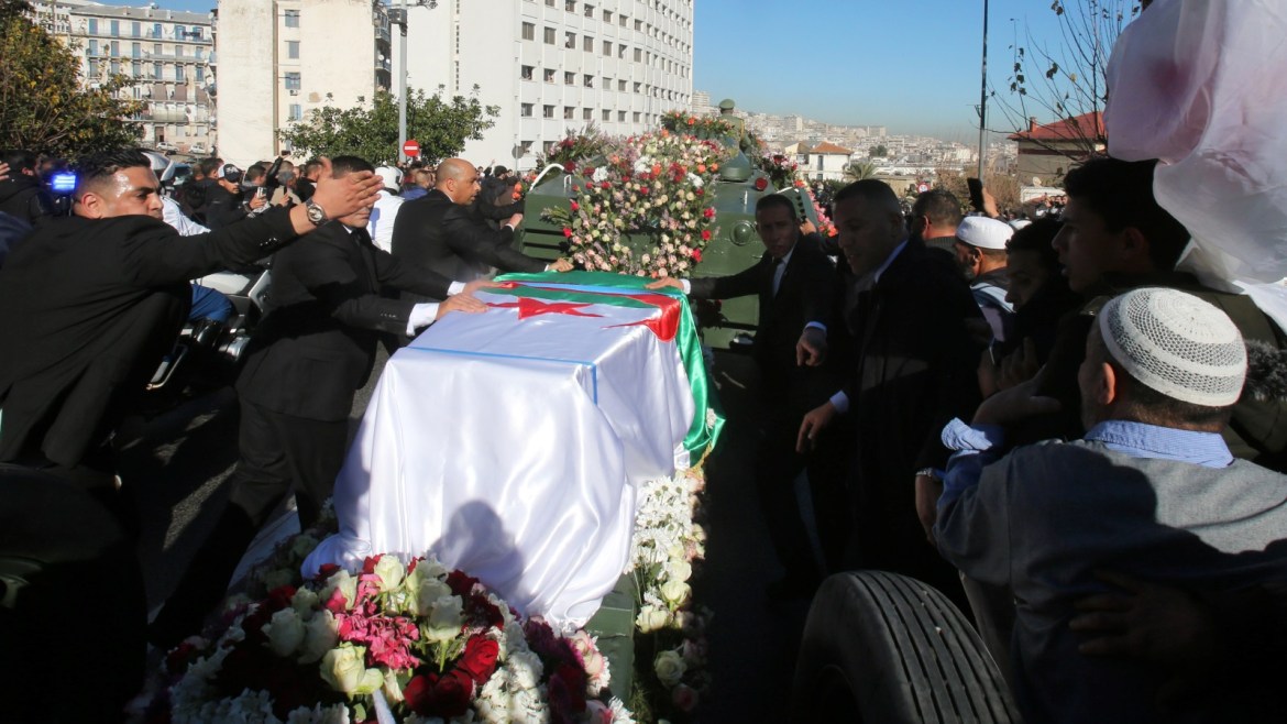 People walk in a funeral procession of Algeria's military chief Lieutenant general Ahmed Gaed Salah in Algiers, Algeria December 25, 2019. REUTERS/Ramzi Boudina