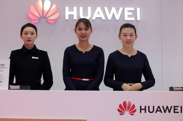 Attendants stand at a Huawei booth at the World 5G Exhibition in Beijing, China November 22, 2019. REUTERS/Jason Lee