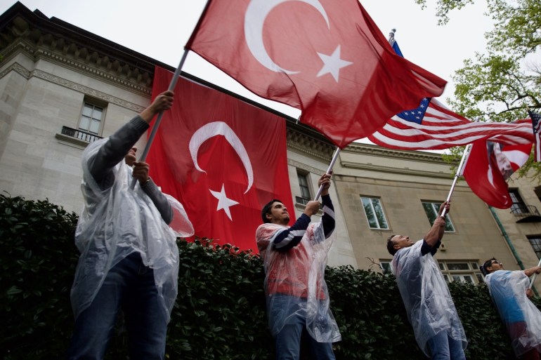 Demonstrations held in US to mark events of 1915- - WASHINGTON DC, USA - APRIL 24: People wave Turkish and US flags during a demonstration in front of the Turkish Embassy in the U.S. capital to mark the 103rd anniversary of the events of 1915 during the First World War in Washington DC, United States on April 24, 2018. Turkish Americans waved Turkish flags and displayed banners saying “Stop Armenian terrorism”, “Let History Decide” and “History cannot be rewritten with