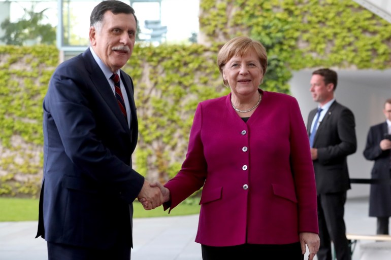 epa07554162 German Chancellor Angela Merkel (R) welcomes Libyan Prime Minister Fayez Al Sarraj (L) for a meeting at the Chancellery in Berlin, Germany, 07 May 2019. EPA-EFE/HAYOUNG JEON
