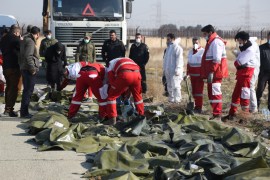 All passengers, crew members killed in Iran plane crash- - TEHRAN, IRAN - JANUARY 08: Dead bodies of passengers are brought from the site by search and rescue team members after a Boeing 737 plane belonging to a Ukrainian airline crashed near Imam Khomeini Airport in Iran just after takeoff with 180 passengers on board in Tehran, Iran on January 08, 2020. All 167 passengers and nine crew members on an Ukrainian 737 plane that crashed near Iran's capital Tehran early Wednesday have died, according to a state official.