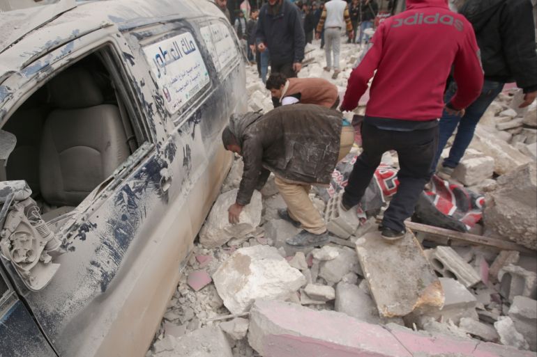 Airstrikes continue to hit Idlib despite the ceasefire- - IDLIB, SYRIA - JANUARY 15: Locals remove rocks and debris around a damaged car after airstrikes of Assad regime and Russia hit a marketplace in Eriha district of Idlib, de-escalation zone, Syria on January 15, 2020 as airstrikes continue despite the ceasefire.