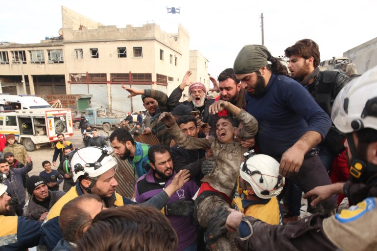 Syrian regime and Russian airstrikes continue killing civilians in Idlib despite ceasefire- - IDLIB, SYRIA - JANUARY 15: Syrians carry a wounded boy after Syrian regime and Russian airstrikes hit central Idlib, Syria on January 15, 2020. At least 10 civilians were killed and many others wounded in the airstrikes. The attacks came despite the recent cease-fire that began early Sunday in the embattled northwestern province of Idlib. Assad regime's attempts to violate the