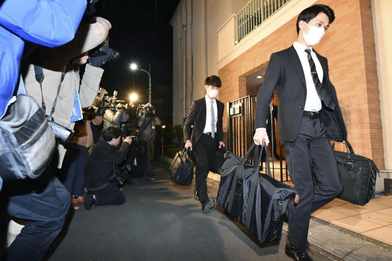 Officials from the Tokyo District Public Prosecutors Office carry bags after raiding the Tokyo residence of former Nissan chairman Carlos Ghosn in Tokyo, Japan in this photo taken by Kyodo January 2, 2020. Mandatory credit Kyodo/via REUTERS ATTENTION EDITORS - THIS IMAGE WAS PROVIDED BY A THIRD PARTY. MANDATORY CREDIT. JAPAN OUT.
