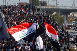 University students hold Iraqi flags during ongoing anti-government protests in Najaf, Iraq January 12, 2020. REUTERS/Alaa al-Marjani