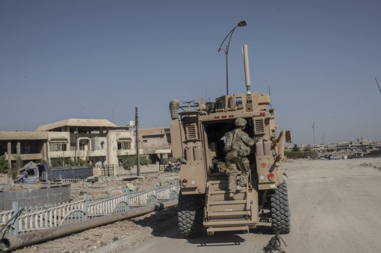 MOSUL, IRAQ - JUNE 21: A U.S. Army 82nd Airborne Division (2nd Brigade) team and an MRAP (mine-resistant vehicle) on June 21, 2017 in west Mosul, Iraq. The Division provides advise and assist support to Iraqi forces. (Martyn Aim/Getty Images)