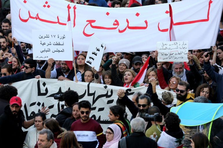 epa08119952 Anti-government protesters hold placards with slogans calling to recover alleged stolen funds, during a protest marching from Dora area to downtown Beirut, Lebanon, 11 January 2020. Protesters were shouting slogans against the newly appointed Lebanese Prime Minister, and against the corruption and demand recovering the stolen money. EPA-EFE/NABIL MOUNZER