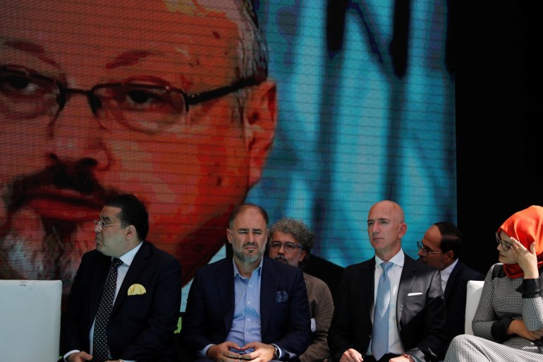 Hatice Cengiz, fiancee of the murdered Saudi journalist Jamal Khashoggi, and Jeff Bezos, founder of Amazon and Blue Origin, are flanked by attendees as they attend a ceremony marking the first anniversary of Khashoggi's killing at the Saudi Consulate in Istanbul, Turkey, October 2, 2019. REUTERS/Umit Bektas