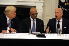 U.S. President Donald Trump and Satya Nadella, CEO of Microsoft Corporation listen as Jeff Bezos, CEO of Amazon speaks during an American Technology Council roundtable at the White House in Washington, U.S., June 19, 2017. REUTERS/Carlos Barria