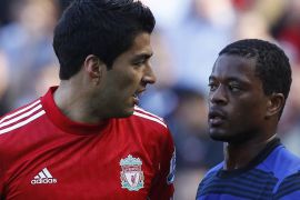 Liverpool's Luis Suarez (L) looks at Manchester United's Patrice Evra (R) during their English Premier League soccer match at Anfield in Liverpool, northern England October 15, 2011. REUTERS/Phil Noble (BRITAIN - Tags: SPORT SOCCER TPX IMAGES OF THE DAY) FOR EDITORIAL USE ONLY. NOT FOR SALE FOR MARKETING OR ADVERTISING CAMPAIGNS. NO USE WITH UNAUTHORIZED AUDIO, VIDEO, DATA, FIXTURE LISTS, CLUB/LEAGUE LOGOS OR