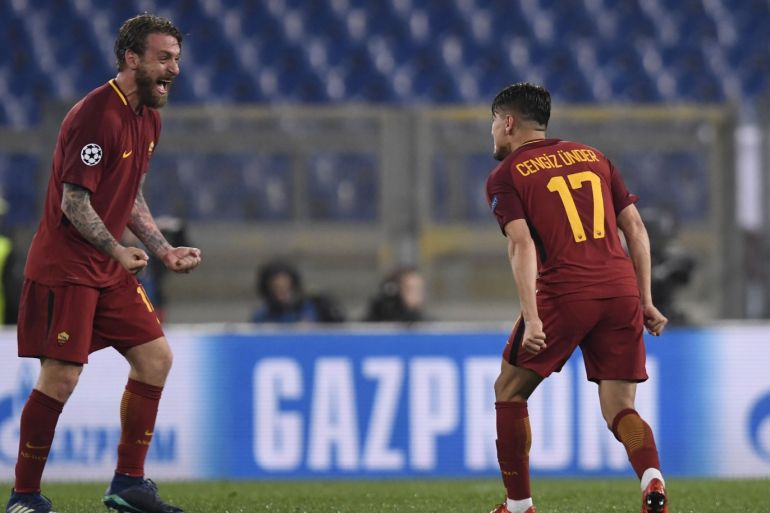 AS Roma vs FC Barcelona - UEFA Champions League- - ROME, ITALY - APRIL 10 : Cengiz Under (17) and Daniele De Rossi (L) of AS Roma celebrate after the UEFA Champions League quarters soccer match between AS Roma and FC Barcelona at the Stadio Olimpico in Rome, Italy on April 10, 2018.