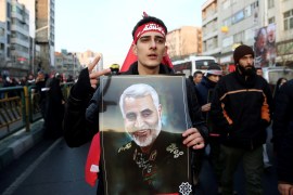 An Iranian man holds a picture of Qassem Soleimani during a funeral procession for Iranian Major-General Qassem Soleimani, head of the elite Quds Force, and Iraqi militia commander Abu Mahdi al-Muhandis, who were killed in an air strike at Baghdad airport, in Tehran, Iran January 6, 2020. Nazanin Tabatabaee/WANA (West Asia News Agency) via REUTERS ATTENTION EDITORS - THIS IMAGE HAS BEEN SUPPLIED BY A THIRD PARTY