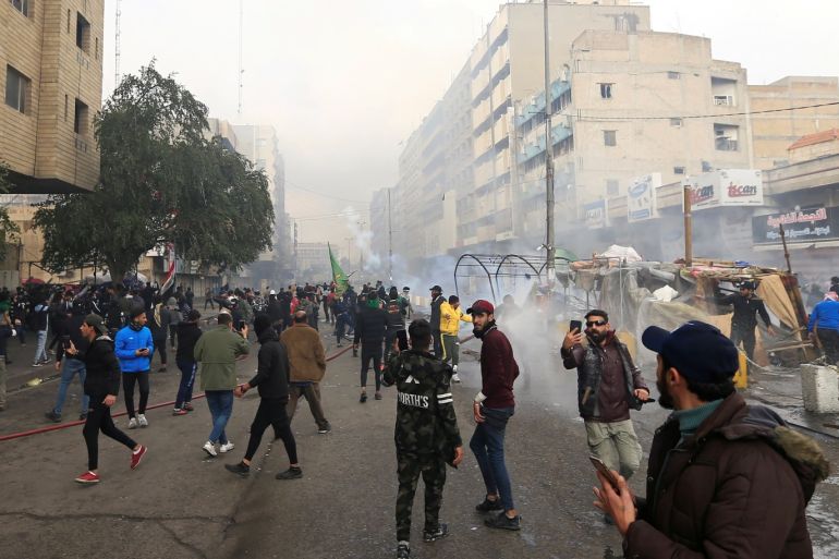 The smoke from burning tents is seen, as Iraqi security forces raided Baghdad's main protest site at Tahrir Square, during ongoing anti-government protests in Baghdad, Iraq January 25, 2020. REUTERS/Thaier al-Sudani