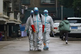 Workers from local disease control and prevention department in protective suits disinfect a residential area following the outbreak of a new coronavirus, in Ruichang, Jiangxi province, China January 25, 2020. Picture taken January 25, 2020. cnsphoto via REUTERS. ATTENTION EDITORS - THIS IMAGE WAS PROVIDED BY A THIRD PARTY. CHINA OUT.