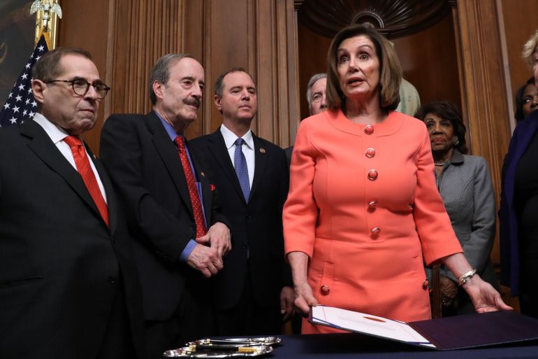 WASHINGTON, DC - JANUARY 15: U.S. Speaker of the House Nancy Pelosi (D-CA) (C) holds the articles of impeachment against President Donald Trump which she signed during an engrossment ceremony with (L-R) Rep. Jerrold Nadler (D-NY), Rep. Eliot Engle (D-NY), Rep. Adam Schiff (D-CA), Rep. Richard Neal (D-MA), Rep. Maxine Waters (D-CA), Rep. Val Demings (D-FL) and Rep. Zoe Lofgren (D-CA) in the Rayburn Room at the U.S. Capitol January 15, 2020 in Washington, DC. The House of Representatives voted to approve the managers and send the articles of impeachment to the Senate, where Majority Leader Mitch McConnell (R-KY) said the trail will begin next Tuesday. Chip Somodevilla/Getty Images/AFP== FOR NEWSPAPERS, INTERNET, TELCOS & TELEVISION USE ONLY ==
