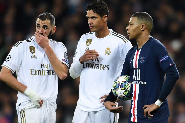MADRID, SPAIN - NOVEMBER 26: Raphael Varane of Real Madrid and Karim Benzema of Real Madrid speaks to Kylian Mbappe of Paris Saint-Germain during the UEFA Champions League group A match between Real Madrid and Paris Saint-Germain at Bernabeu on November 26, 2019 in Madrid, Spain. (Photo by David Ramos/Getty Images)