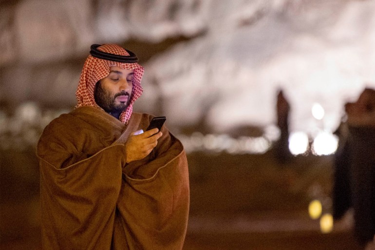 Saudi Arabia's Crown Prince Mohammed bin Salman uses his phone during a meeting with Japan's Prime Minister Shinzo Abe in Riyadh, Saudi Arabia January 12, 2020. Picture taken January 12, 2020. Bandar Algaloud/Courtesy of Saudi Royal Court/Handout via REUTERS ATTENTION EDITORS - THIS PICTURE WAS PROVIDED BY A THIRD PARTY