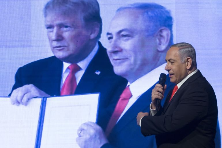 JERUSALEM, ISRAEL - JANUARY 21: Israeli Prime Minister, Benjamin Netanyahu stand near a photo showing him and US President Donald Trump shake hand as he speaks to supporters at a Likud Party campaign rally on January 21, 2020 in Jerusalem, Israel. Israel to hold third election in less than a year after politicans faild to form a coalition. (Photo by Amir Levy/Getty Images)